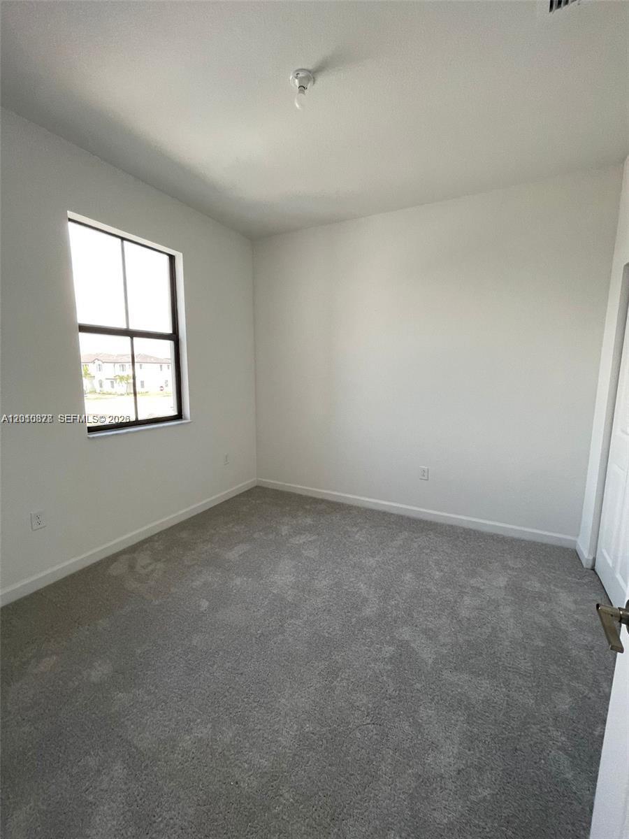 24641 Southwest 117th Path, Unit 24641 Homestead, FL 33032 - Photo 8 of 9 an empty room with windows