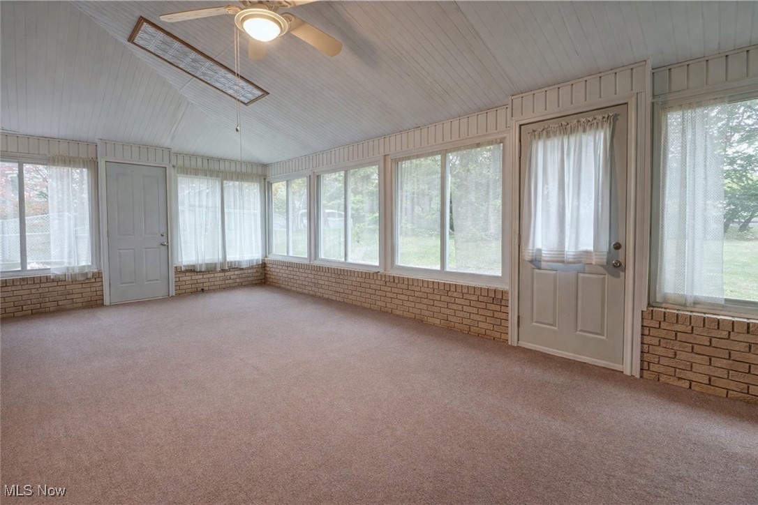 14965 Seacrist Road Salem, OH 44460 - Photo 20 of 43 Unfurnished sunroom with brick wall, carpet floors, and wooden ceiling