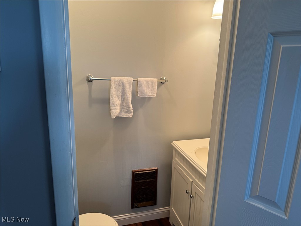 1790 Rix Mills Road New Concord, OH 43762 - Photo 17 of 28 Half bathroom featuring toilet, vanity, and wood finished floors