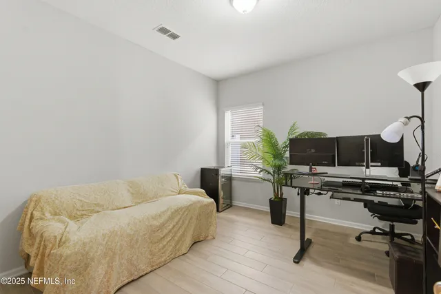a bathroom with a sink mirror toilet and next to a window