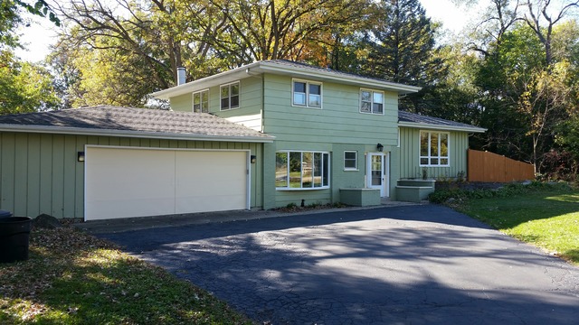 39232 North Rustic Drive Lake Villa, IL 60046 - Photo 1 of 12 a front view of a house with a garden