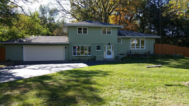 39232 North Rustic Drive Lake Villa, IL 60046 - Photo 4 of 12 a front view of a house with a yard and garage