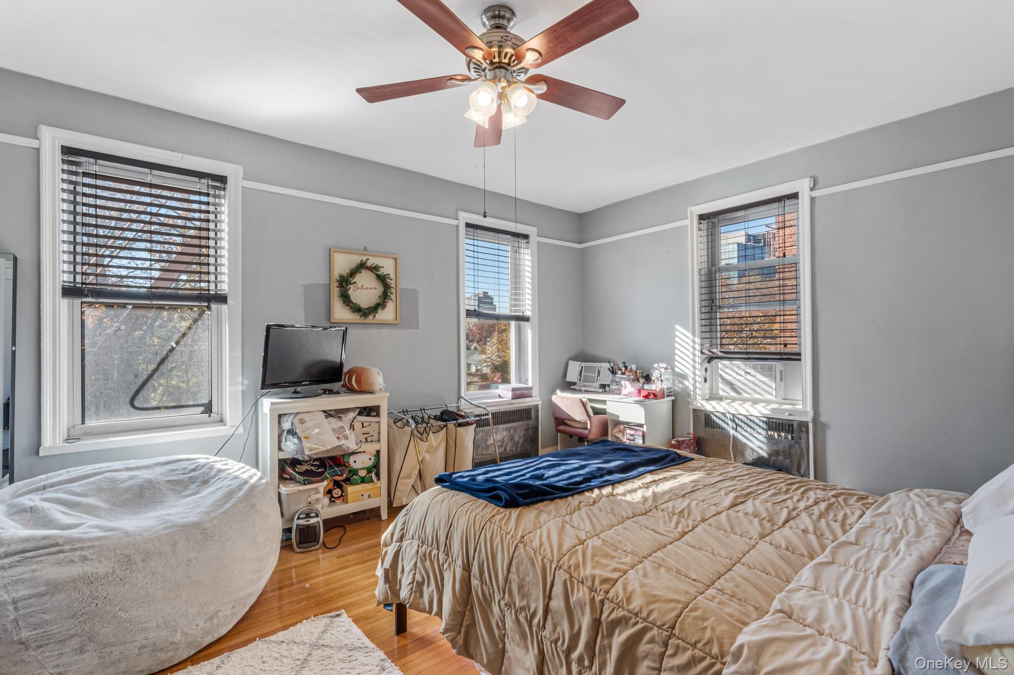 45 Kew Gardens Road, Unit 4A Queens, NY 11415 - Photo 11 of 19 a bedroom that has a bed and a chandelier