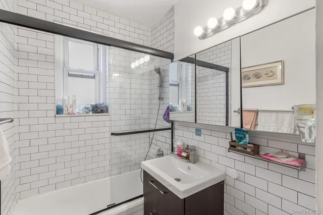 a kitchen with kitchen island granite countertop a sink cabinets and window