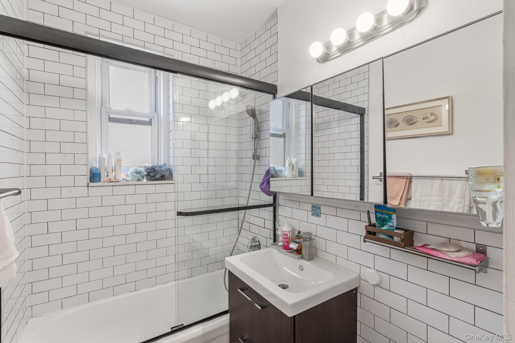 45 Kew Gardens Road, Unit 4A Queens, NY 11415 - Photo 7 of 19 a bathroom with a sink and a mirror