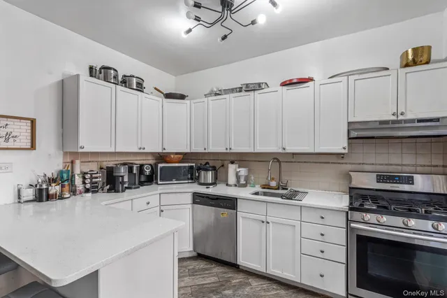 a kitchen with a refrigerator and cabinets