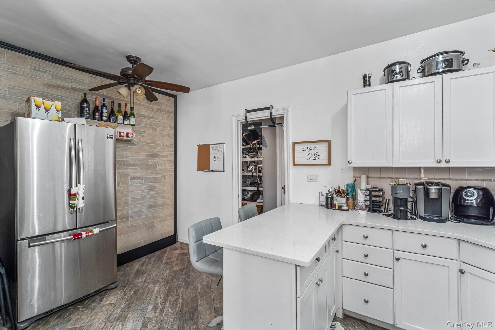 45 Kew Gardens Road, Unit 4A Queens, NY 11415 - Photo 10 of 19 a kitchen with a refrigerator and cabinets