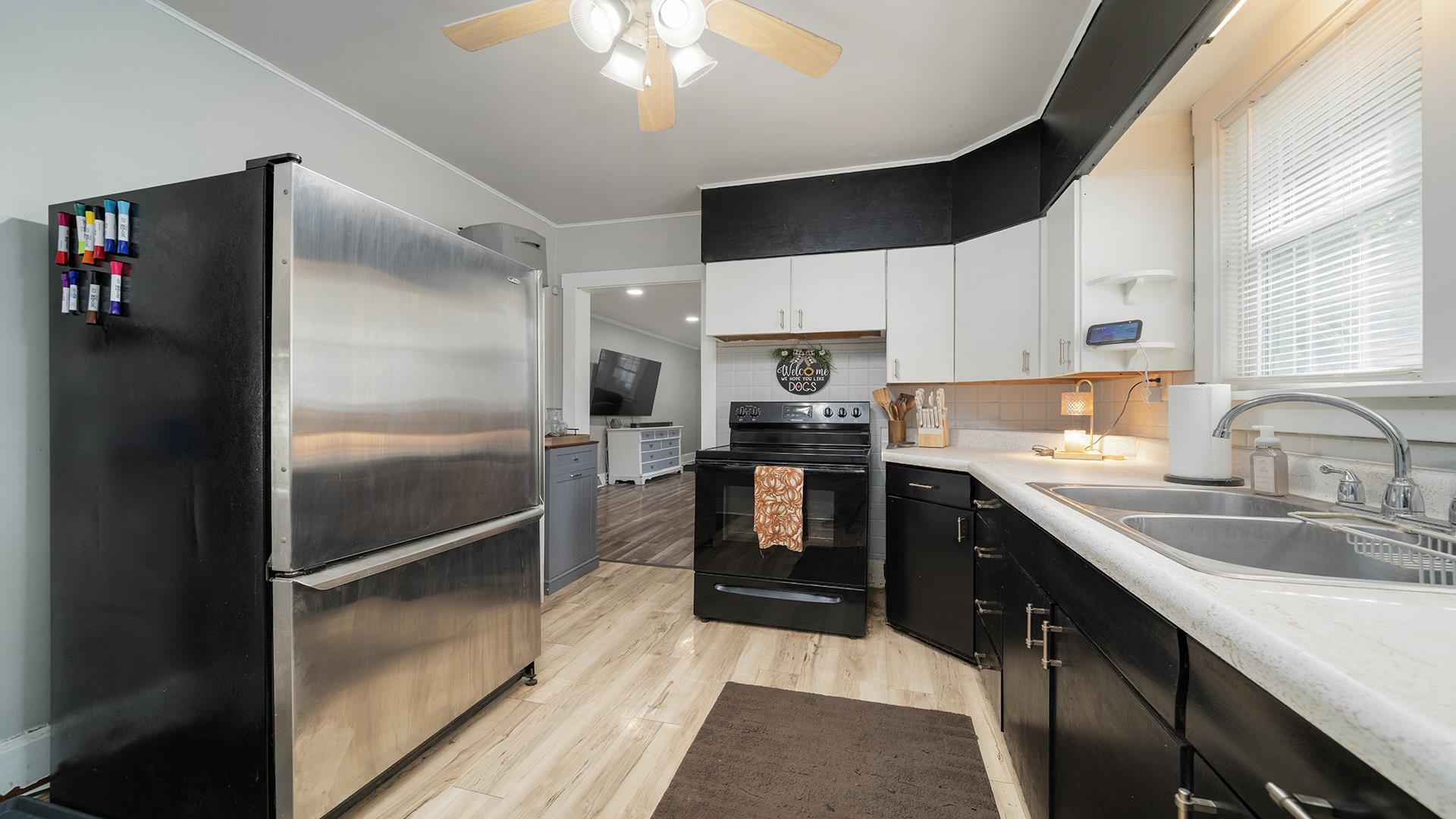 708 West Washington Street Oregon, IL 61061 - Photo 12 of 26 a kitchen with kitchen island granite countertop a refrigerator a sink a stove and cabinets