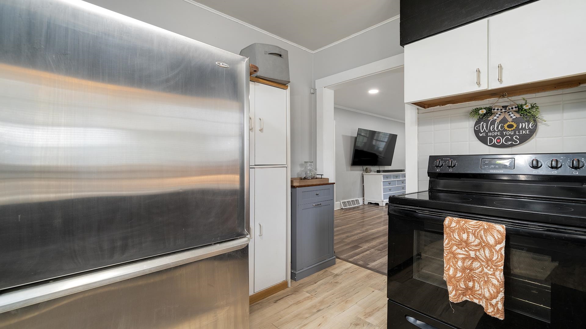 708 West Washington Street Oregon, IL 61061 - Photo 13 of 26 a view of a refrigerator in kitchen and an empty room