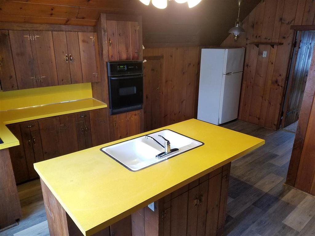 708 West Washington Street Oregon, IL 61061 - Photo 19 of 26 a view of a kitchen with stainless steel appliances wooden floor and a refrigerator