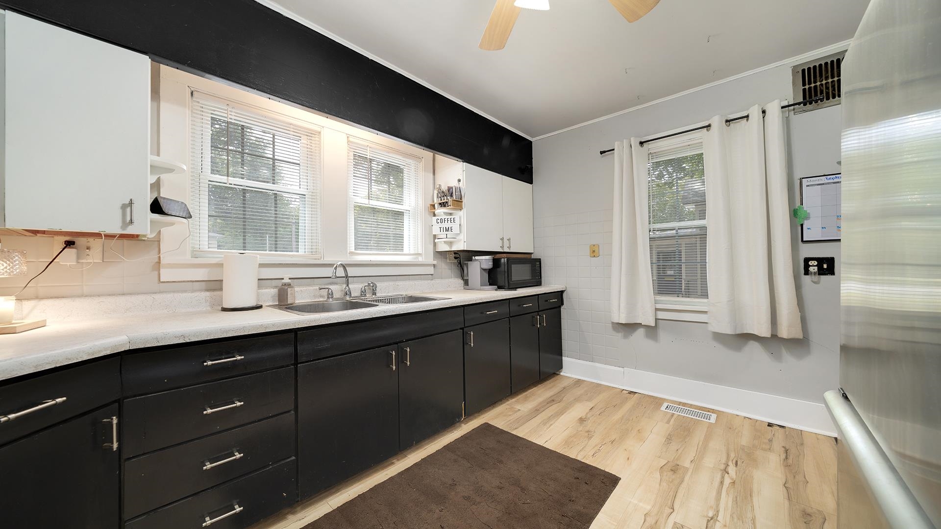 708 West Washington Street Oregon, IL 61061 - Photo 10 of 26 a large kitchen with a sink window and refrigerator