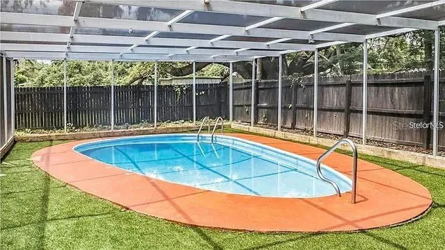 a view of a backyard with swimming pool