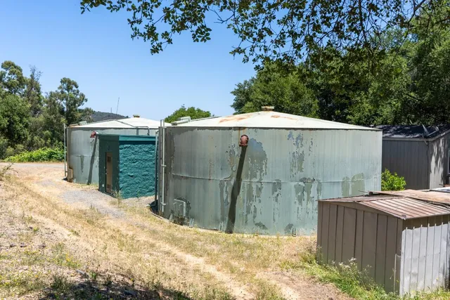 an aerial view of green landscape with trees houses and mountain view