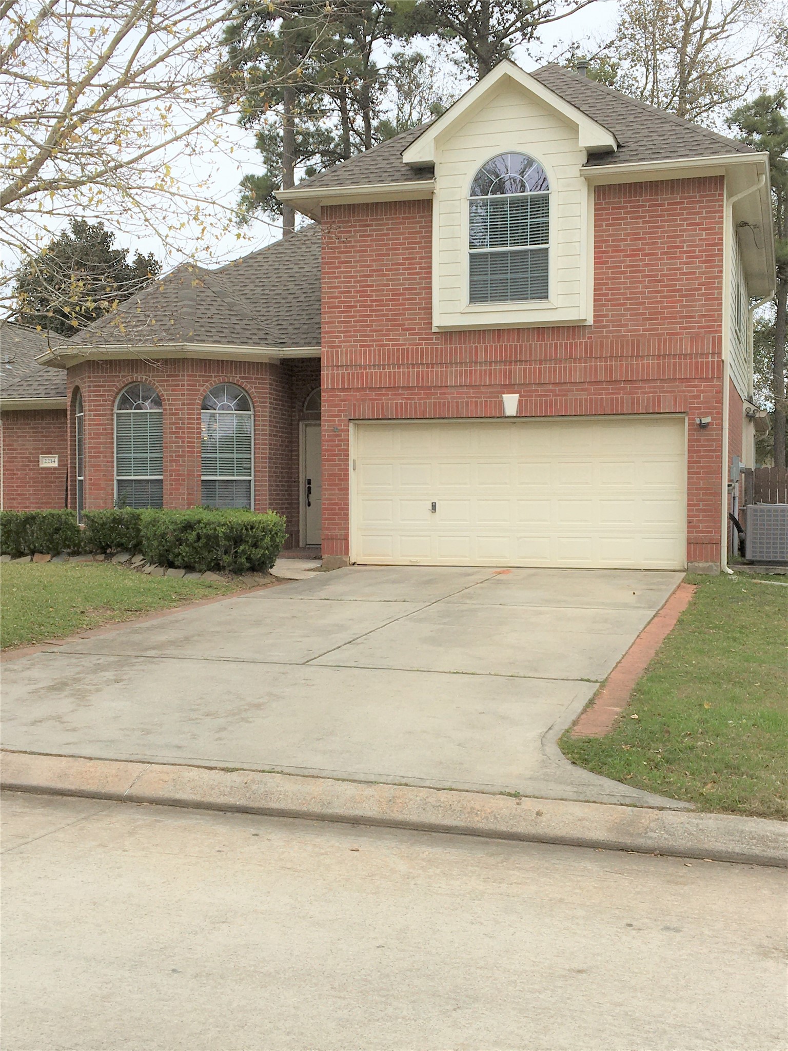 2214 Valley View Crossing Conroe, TX 77304 - Photo 3 of 23 a front view of a house with a yard and garage