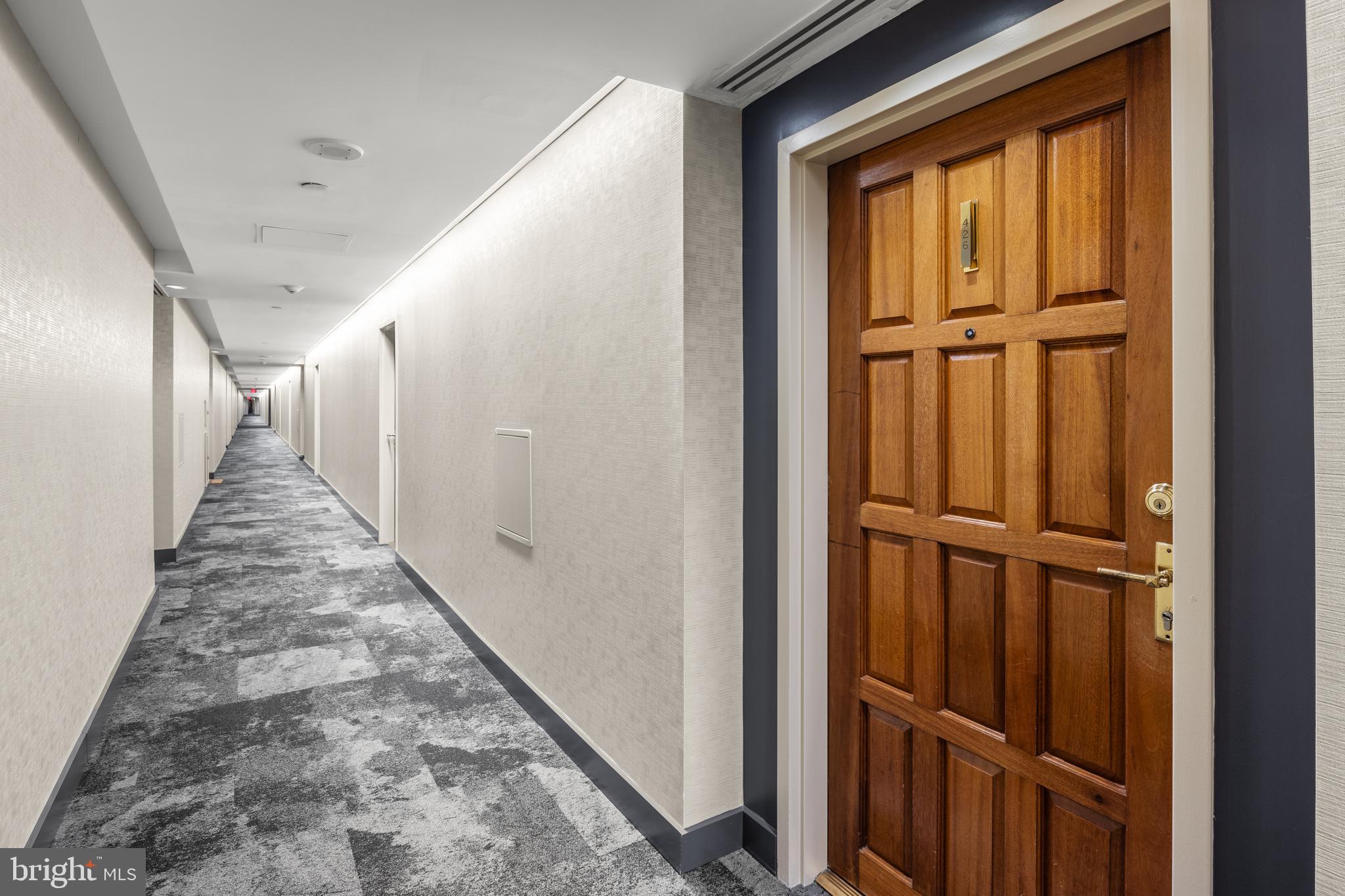 1530 Key Boulevard, Unit 426 Arlington, VA 22209 - Photo 2 of 43 a view of a hallway with wooden floor and staircase
