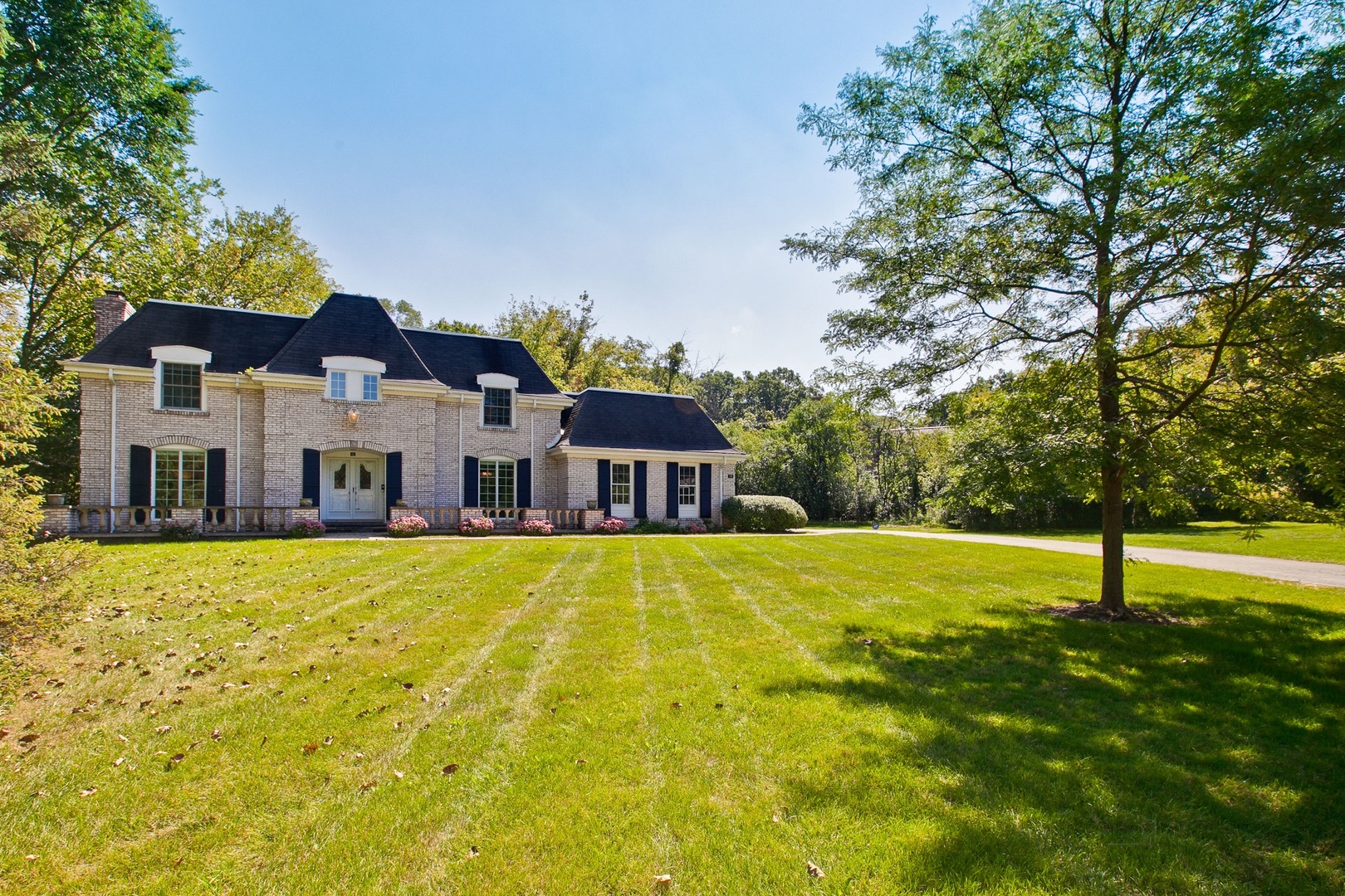 13 Forest Hills Road Lake Bluff, IL 60044 - Photo 1 of 24 a front view of a house with a yard