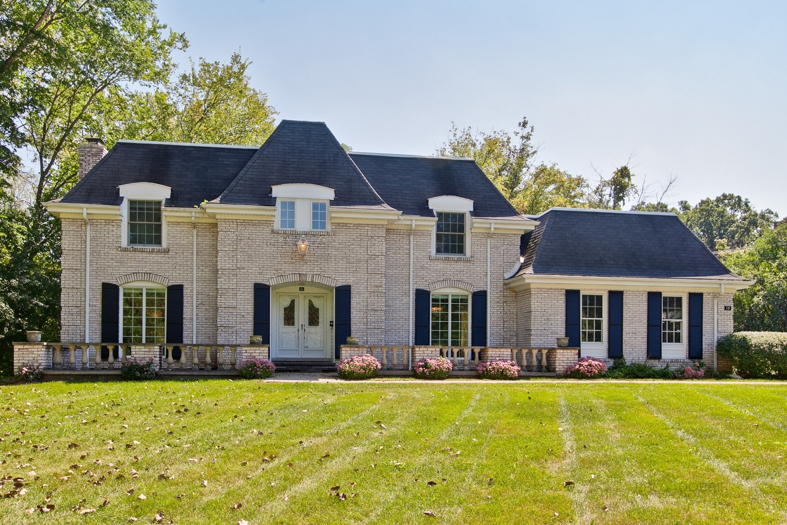 13 Forest Hills Road Lake Bluff, IL 60044 - Photo 2 of 24 a front view of a house with a yard