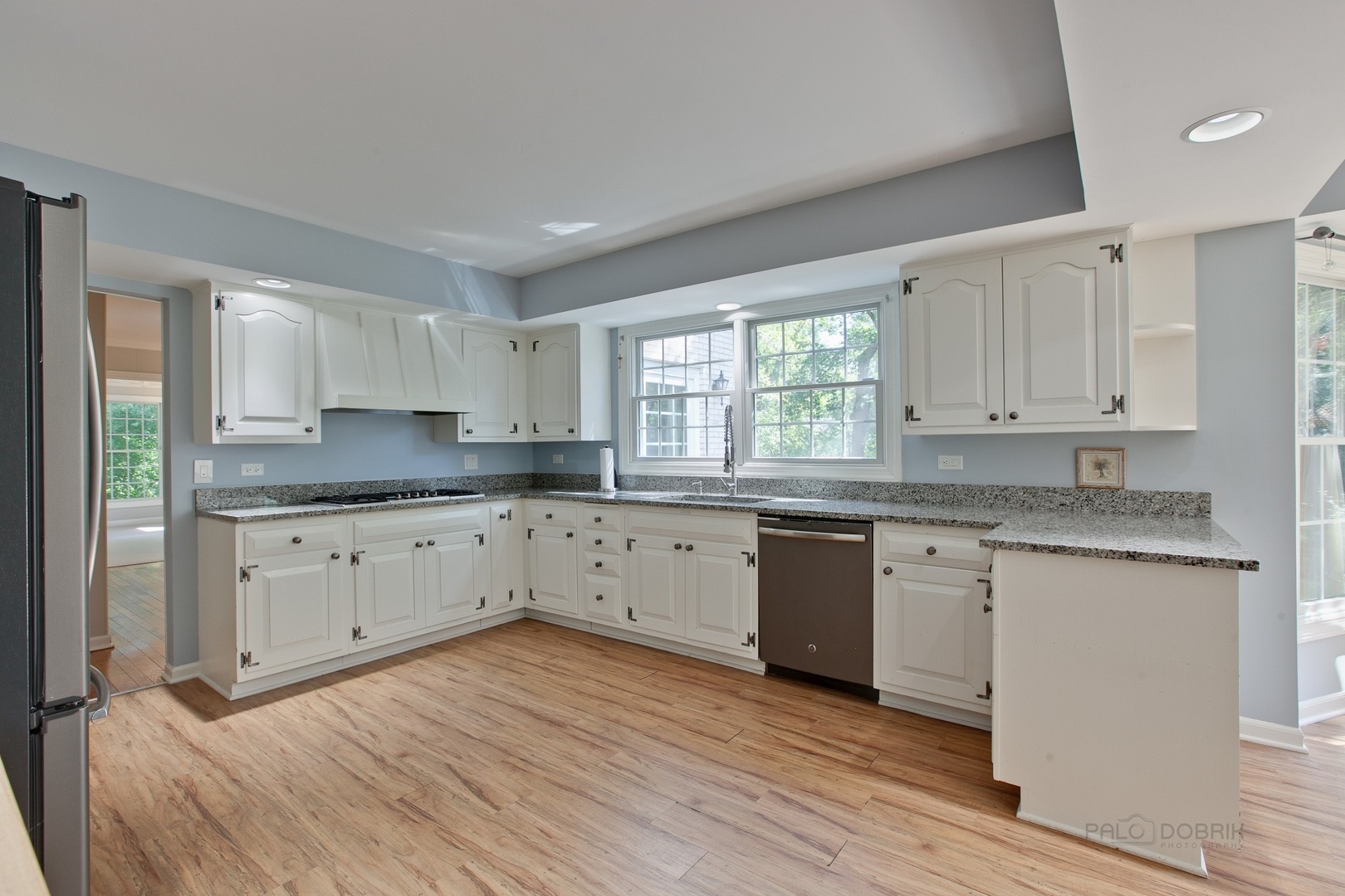 13 Forest Hills Road Lake Bluff, IL 60044 - Photo 12 of 24 a kitchen with granite countertop white cabinets a sink a window and stainless steel appliances