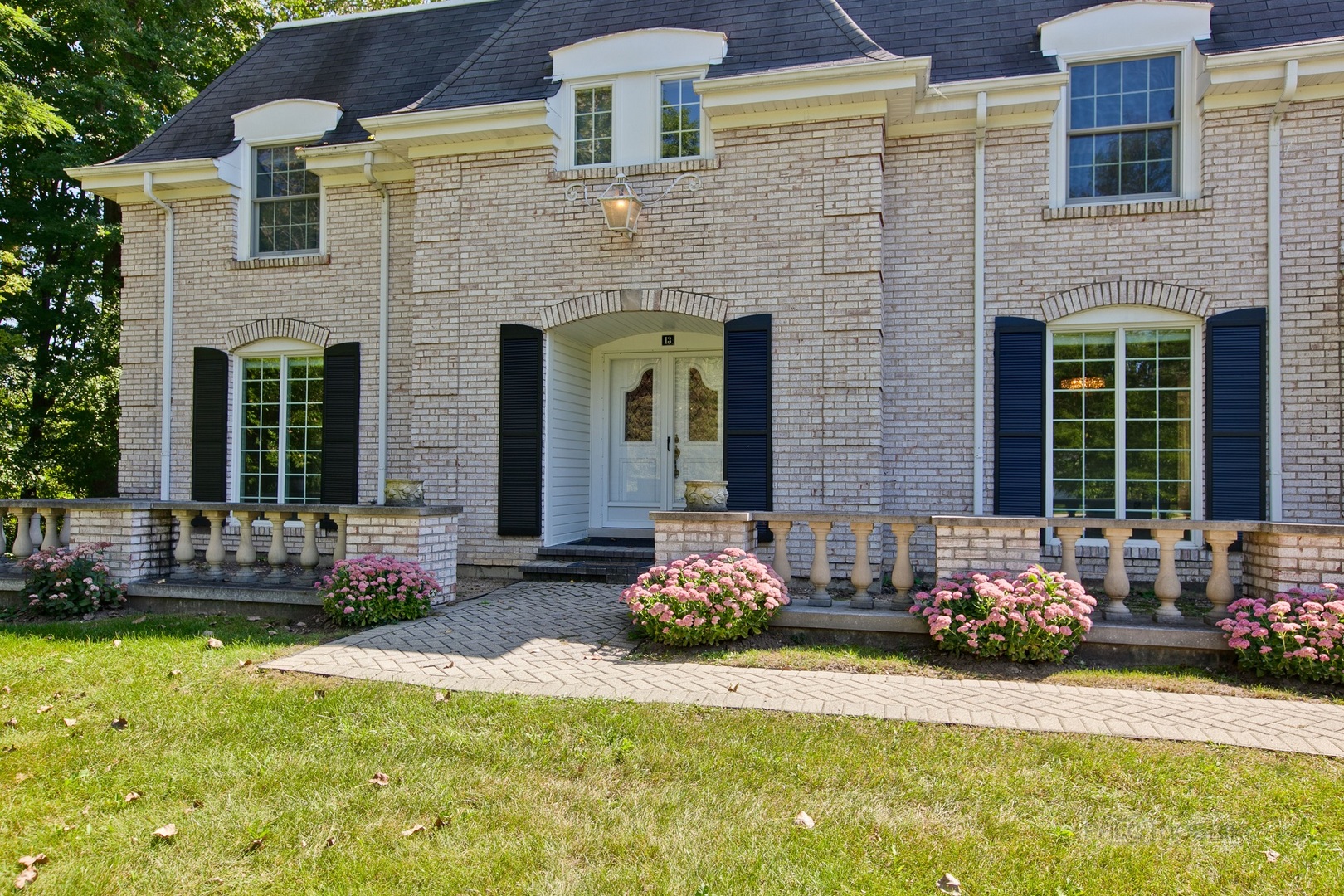 13 Forest Hills Road Lake Bluff, IL 60044 - Photo 3 of 24 a front view of a house with outdoor seating