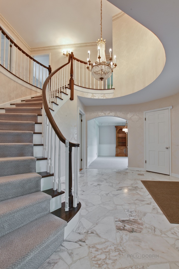 13 Forest Hills Road Lake Bluff, IL 60044 - Photo 5 of 24 a view of entryway and hall with a chandelier