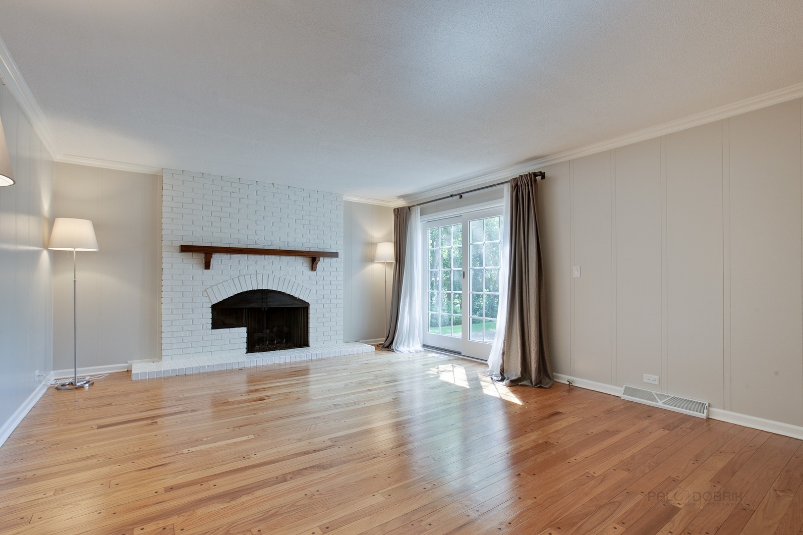 13 Forest Hills Road Lake Bluff, IL 60044 - Photo 8 of 24 a view of an empty room with wooden floor fireplace and a window