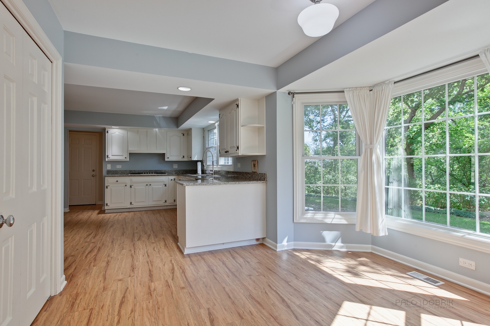 13 Forest Hills Road Lake Bluff, IL 60044 - Photo 10 of 24 a kitchen with wooden floors and white cabinets