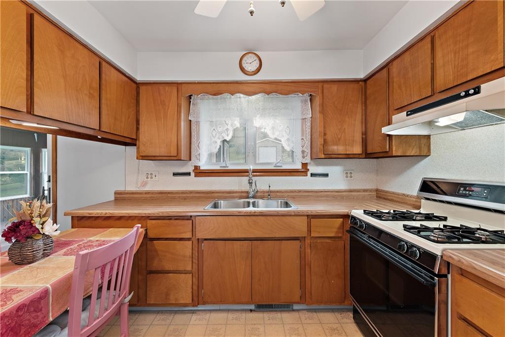 604 Davidson Drive Rochester, PA 15074 - Photo 13 of 25 a kitchen with stainless steel appliances a stove a sink and a microwave