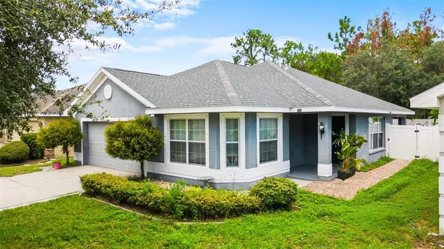 a front view of a house with a yard and porch