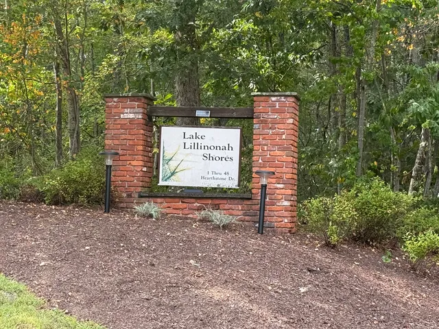 a sign board with a bench in a yard