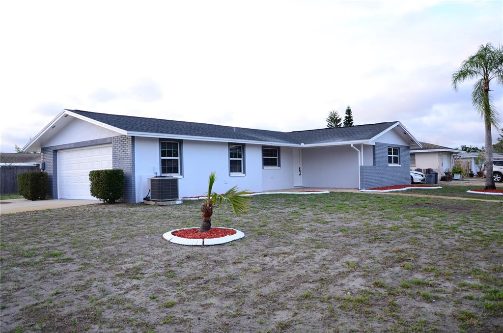 10433 Laburnum Drive Port Richey, FL 34668 - Photo 1 of 26 a house view with a backyard space
