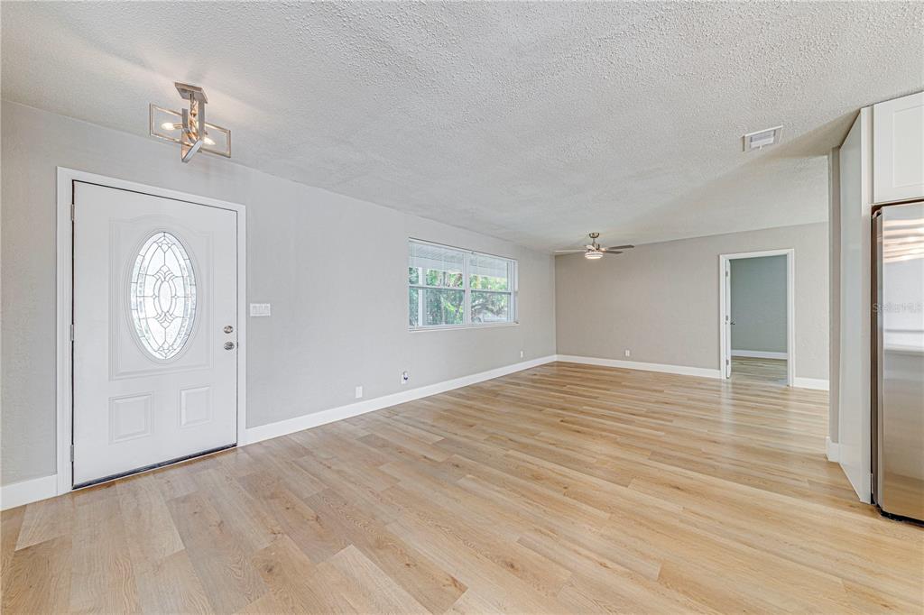 1648 Caldwell Road Daytona Beach, FL 32119 - Photo 13 of 45 a view of empty room with wooden floor and window