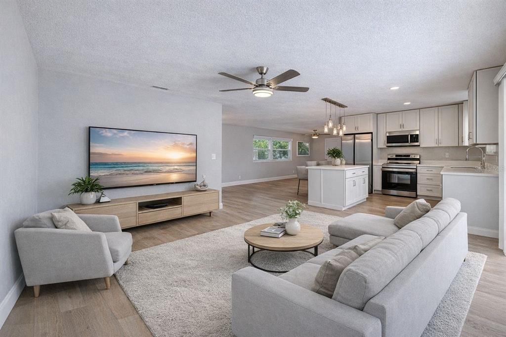 1648 Caldwell Road Daytona Beach, FL 32119 - Photo 7 of 45 a living room with furniture kitchen view and a flat screen tv