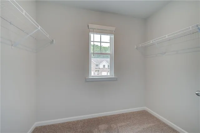 an empty room with closet and ceiling fan