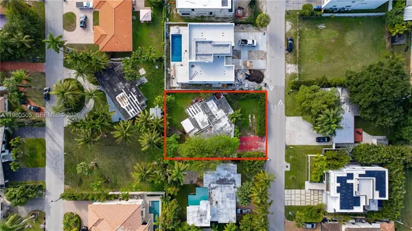 an aerial view of residential houses with outdoor space and swimming pool