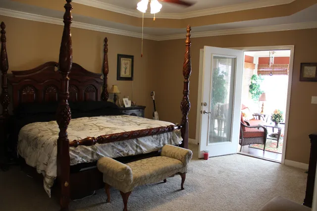 a bedroom with a bed and a chandelier