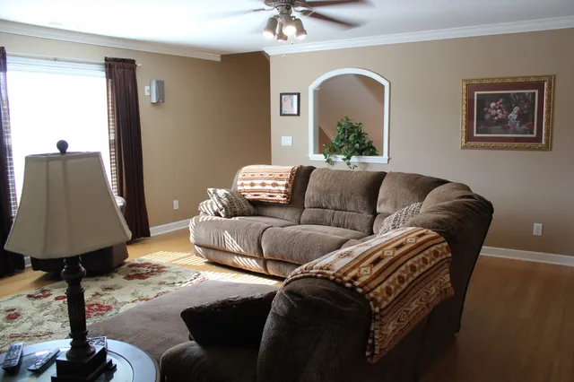 a living room with furniture and wooden floor