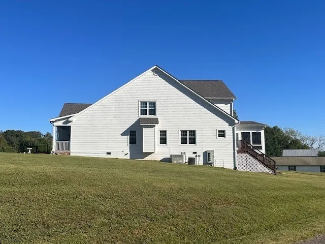 a view of a house with backyard and porch