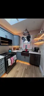a kitchen with stainless steel appliances a stove a sink dishwasher and cabinets