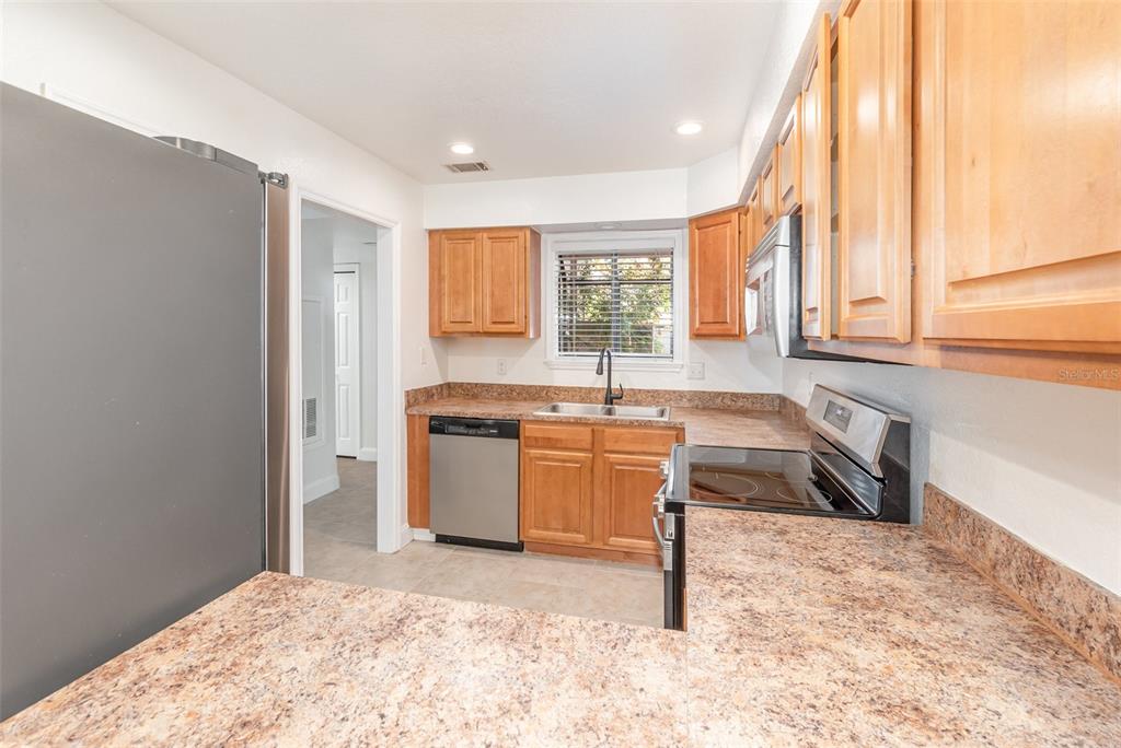 940 Douglas Avenue, Unit 175 Altamonte Springs, FL 32714 - Photo 12 of 44 a kitchen with a stove a sink and a refrigerator