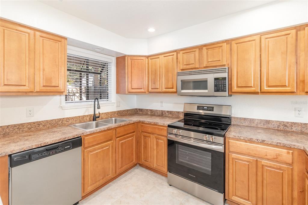 940 Douglas Avenue, Unit 175 Altamonte Springs, FL 32714 - Photo 13 of 44 a kitchen with granite countertop a sink stove and microwave