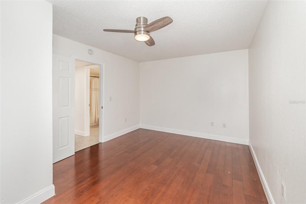 940 Douglas Avenue, Unit 175 Altamonte Springs, FL 32714 - Photo 17 of 44 an empty room with wooden floor and ceiling fan