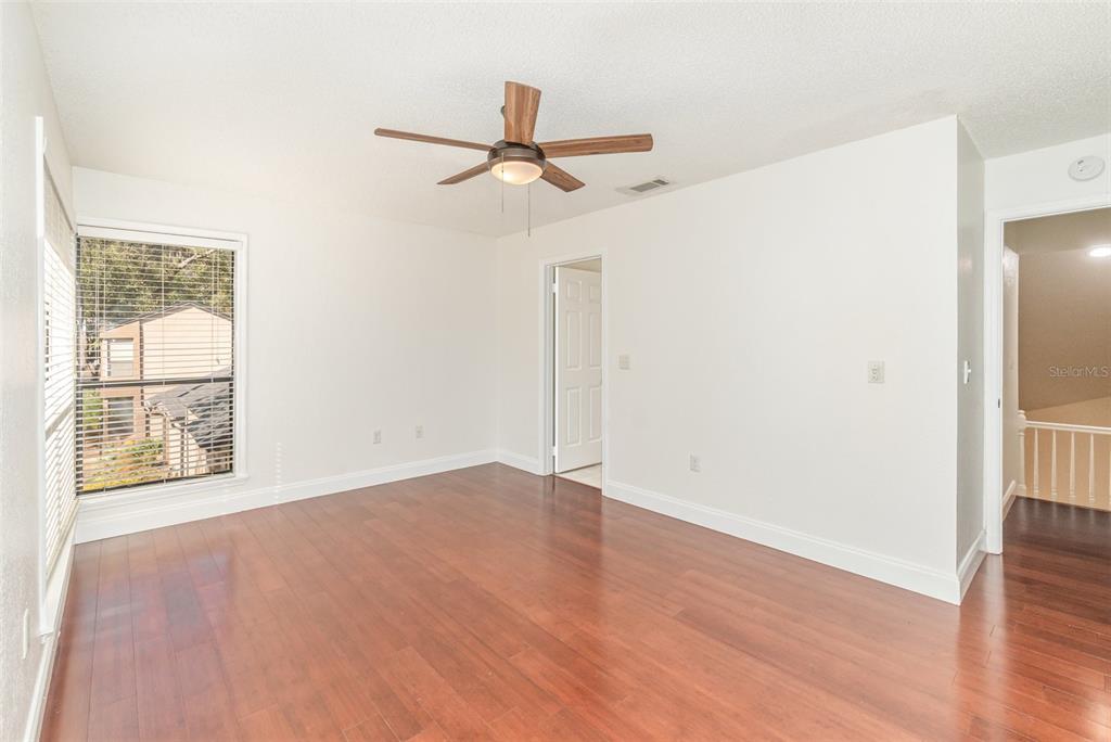 940 Douglas Avenue, Unit 175 Altamonte Springs, FL 32714 - Photo 20 of 44 a view of an empty room with wooden floor and a window
