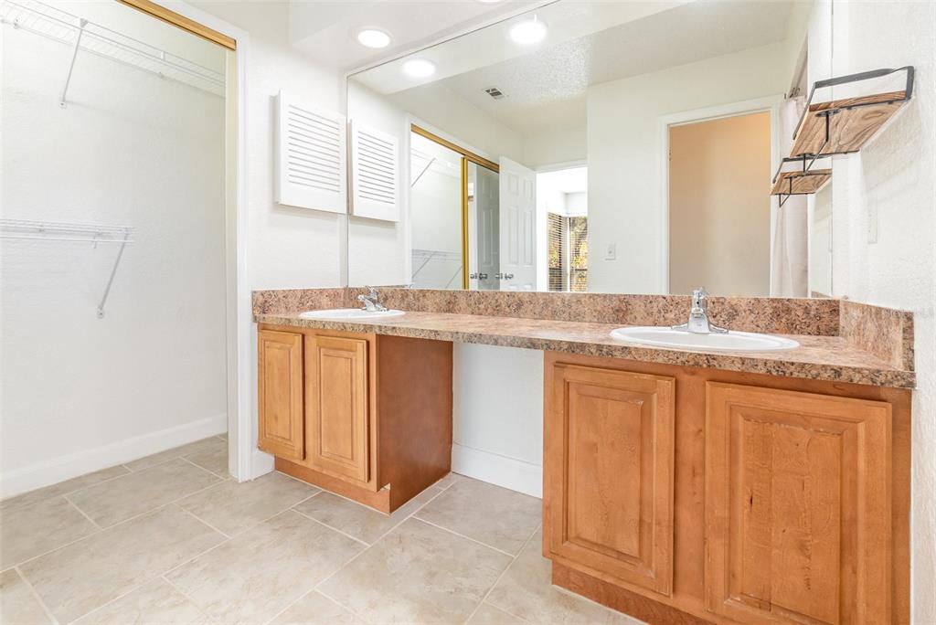 940 Douglas Avenue, Unit 175 Altamonte Springs, FL 32714 - Photo 22 of 44 a bathroom with a granite countertop sink and a mirror