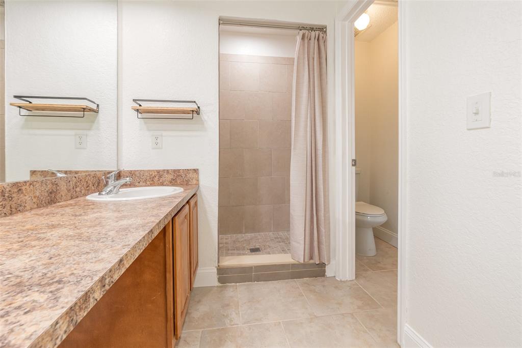 940 Douglas Avenue, Unit 175 Altamonte Springs, FL 32714 - Photo 23 of 44 a bathroom with a granite countertop sink and a mirror
