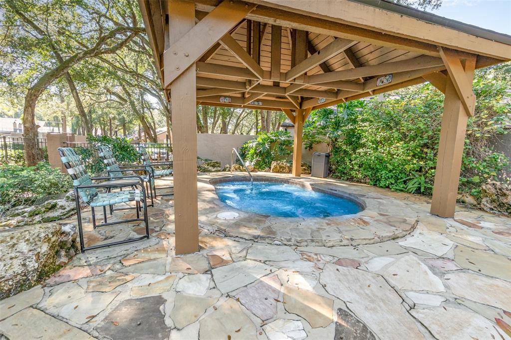 940 Douglas Avenue, Unit 175 Altamonte Springs, FL 32714 - Photo 36 of 44 a view of a backyard with table and chairs under an umbrella with a small yard