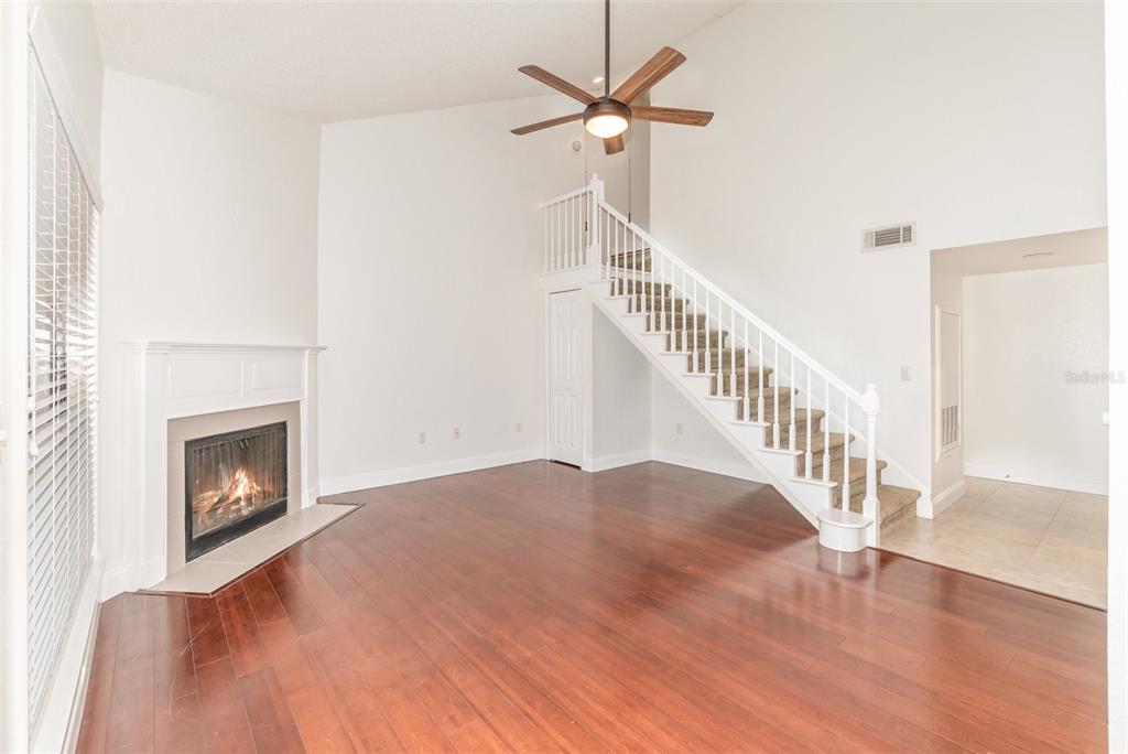 940 Douglas Avenue, Unit 175 Altamonte Springs, FL 32714 - Photo 9 of 44 a view of empty room with fireplace and wooden floor