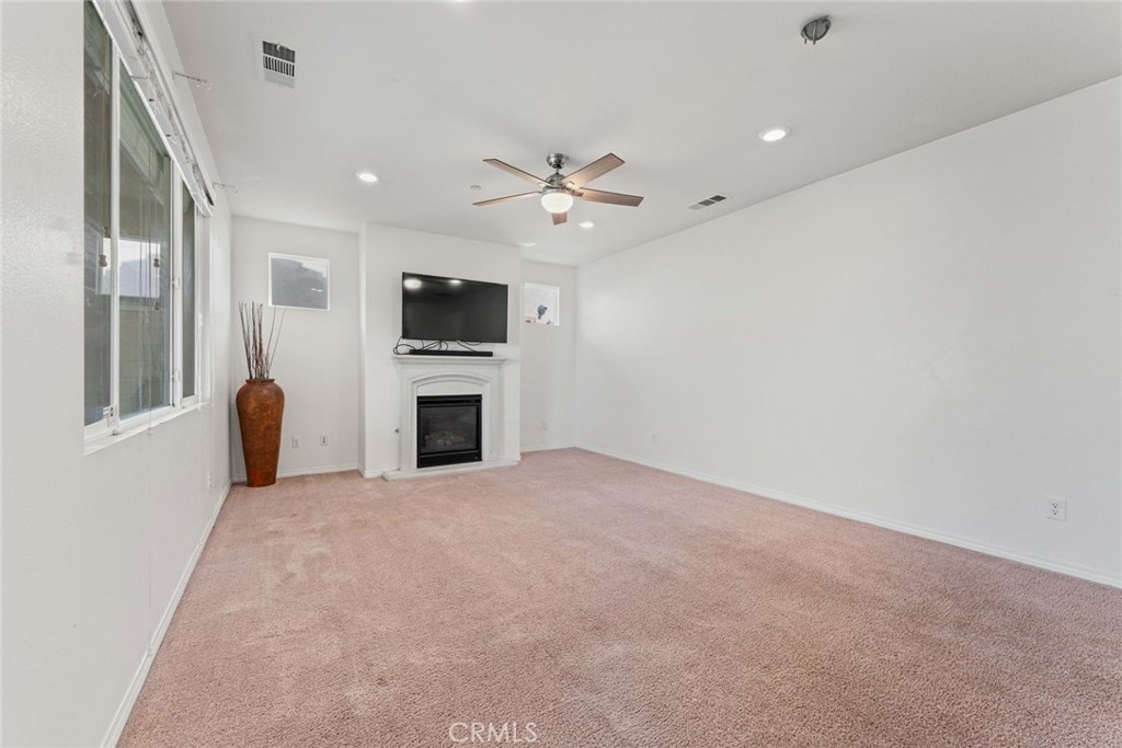 8022-8022 Sea Salt Avenue Fontana, CA 92336 - Photo 15 of 35 a view of a livingroom with a fireplace