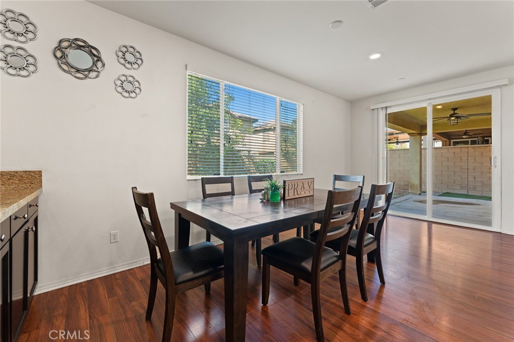 8022-8022 Sea Salt Avenue Fontana, CA 92336 - Photo 17 of 35 a view of a dining room with furniture window and wooden floor