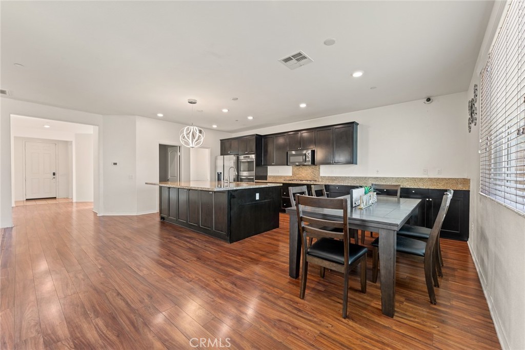 8022-8022 Sea Salt Avenue Fontana, CA 92336 - Photo 18 of 35 a view of kitchen with cabinets and wooden floor