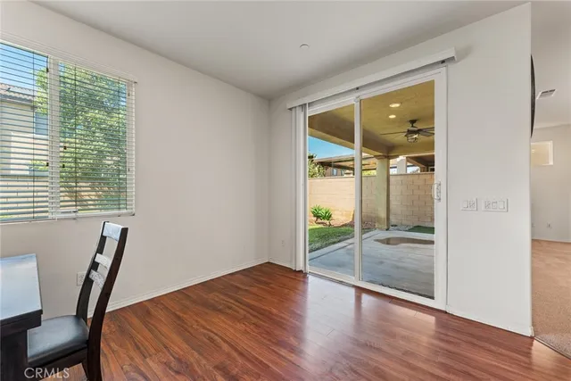 a room with wooden floor and windows